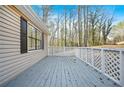 Home's wooden deck overlooking the trees in the backyard at 3730 N Quail Dr, Douglasville, GA 30135