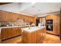 Spacious kitchen featuring wood cabinets, white countertops, and modern appliances at 6575 Roundhill Ct, Cumming, GA 30040