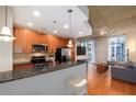 Well-lit kitchen with granite countertops, stainless steel appliances, and an open layout into the living area at 855 Peachtree Ne St # 1911, Atlanta, GA 30308