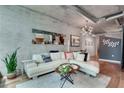 Cozy living room featuring a leather sofa, gray accent walls, and hardwood floors at 923 Peachtree Ne St # 1527, Atlanta, GA 30309