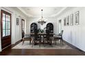 Elegant dining room featuring hardwood floors, sophisticated chandelier, and ample seating at 200 Rivermere Way, Sandy Springs, GA 30350