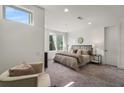 Bright main bedroom with a comfortable bed, chair, and large windows at 241 Maynard Se Ter # 17, Atlanta, GA 30316