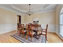 Formal dining room featuring classic wainscoting and decorative rug at 525 Water Shadow Ln, Alpharetta, GA 30022