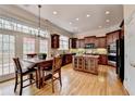 Well-equipped kitchen with granite countertops, dark wood cabinetry, and a center island at 525 Water Shadow Ln, Alpharetta, GA 30022