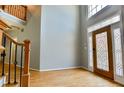 Welcoming foyer with hardwood floors, ornate front door, and staircase at 4129 Lansfaire Ter, Suwanee, GA 30024
