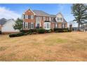 Beautifully landscaped brick home with mature trees and a large front lawn at 5292 Candleberry Sw Dr, Lilburn, GA 30047