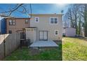 A view of the home's backyard featuring a fenced in yard, a concrete patio and green grass at 2102 Lenoa Ln, Austell, GA 30106