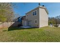 A view of the home's backyard featuring a fenced in yard, a concrete patio and green grass at 2102 Lenoa Ln, Austell, GA 30106