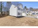 Well-manicured side yard of home featuring low maintenance landscape, and neighborhing properties at 42 Springbottom Dr, Lawrenceville, GA 30046