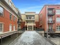 View of condo with red brick exterior featuring balconies and a bridge entranceway at 560 Dutch Valley Ne Rd # 2301, Atlanta, GA 30324