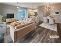 Bright, open-concept living room featuring modern furniture, contemporary lighting, and seamless kitchen access at 560 Dutch Valley Ne Rd # 2301, Atlanta, GA 30324