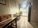 Compact kitchen with white cabinetry, essential appliances, and a dining table near the window at 20 Nw Marietta St, Atlanta, GA 30303