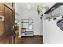 Inviting entryway with wood floors, a modern mirror, coat rack, and view into the living spaces, adding functionality at 1742 Ridgeway Nw Ave, Atlanta, GA 30318