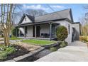 Charming home with a covered front porch, stone walkway, and well-maintained landscaping, offering great curb appeal at 1742 Ridgeway Nw Ave, Atlanta, GA 30318