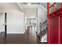 Welcoming foyer with hardwood floors, staircase with iron railings, and a glimpse of the living spaces at 702 Ridgeway Ct, Canton, GA 30114