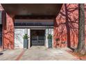 Inviting exterior entrance to Kessler City Lofts features brick facade and manicured greenery at 87 Peachtree Sw St # 204, Atlanta, GA 30303
