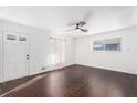 Bright living room featuring hardwood floors, fresh paint, and a modern ceiling fan at 1496 Greenwillow Dr, Conley, GA 30288