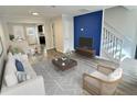 Inviting living room with modern decor, hardwood floors, and staircase, perfect for relaxation and entertaining at 235 Winding River Dr # B, Sandy Springs, GA 30350