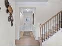 Bright foyer with stairs, wainscoting and neutral decor. and access to multiple rooms at 523 Lanier Way, Temple, GA 30179