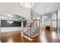 Elegant foyer with high ceilings, a grand staircase, and gleaming hardwood floors at 925 Sentry Ridge Xing, Suwanee, GA 30024