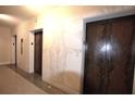 Hallway with wood-paneled elevators and marble walls for a luxurious aesthetic at 32 Peachtree Nw St # 202, Atlanta, GA 30303