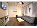A modern living room featuring hardwood floors, a comfortable couch, and a flat-screen television for entertainment at 32 Peachtree Nw St # 202, Atlanta, GA 30303