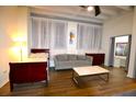 Comfortable living room setup with a cozy sofa, a bed, and a coffee table, perfect for relaxing and entertaining at 32 Peachtree Nw St # 202, Atlanta, GA 30303