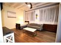 Bright living space with hardwood floors, white walls, a comfortable couch, and large windows for natural light at 32 Peachtree Nw St # 202, Atlanta, GA 30303
