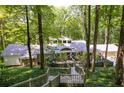 Stunning home exterior nestled in a wooded area with a walkway leading to the entrance at 385 Grimes Bridge Rd, Roswell, GA 30075