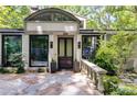 Welcoming front entrance with stone walkway, manicured landscaping, and modern lighting fixtures at 385 Grimes Bridge Rd, Roswell, GA 30075