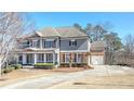 Charming two-story home featuring a inviting front porch and attached two car garage at 114 Rock Creek Ln, Canton, GA 30114