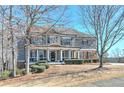Charming two-story home with a inviting front porch and beautiful landscaping at 114 Rock Creek Ln, Canton, GA 30114
