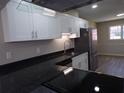 A close-up of the kitchen highlighting the countertops, range, and white cabinets at 2401 Northlake Ct, Atlanta, GA 30345