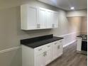 Bright kitchen with white cabinets, granite countertops, and modern stainless steel appliances at 2401 Northlake Ct, Atlanta, GA 30345