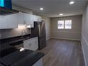 Kitchen features stainless steel appliances, white cabinets, granite countertops, and updated flooring at 2401 Northlake Ct, Atlanta, GA 30345