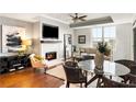 Bright living room featuring a fireplace, dining area, and comfortable seating at 2881 Peachtree Ne Rd # 702, Atlanta, GA 30305