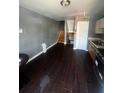 Living room features wood floors, and access to the staircase and kitchen at 405 Fairburn Sw Rd, Atlanta, GA 30331