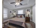 Cozy bedroom featuring a ceiling fan, neutral walls, and bright natural light at 1532 Pineview Sw Ter, Atlanta, GA 30311
