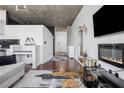 Stylish modern interior features hardwood floors, an electric fireplace, and a view through large windows at 3324 Peachtree Ne Rd # 1115, Atlanta, GA 30326