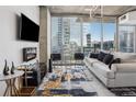 Contemporary living room featuring an electric fireplace, large windows, and views of the city skyline at 3324 Peachtree Ne Rd # 1115, Atlanta, GA 30326
