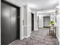 Hallway with elevator access featuring contemporary decor at 795 Hammond Dr # 1405, Atlanta, GA 30328