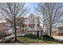 Stately multi-story home with balconies and manicured landscaping enhancing its curb appeal at 1354 Fernwood Ne Cir, Brookhaven, GA 30319