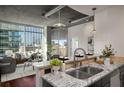 Modern kitchen featuring granite countertops, stainless steel sink, and city views at 943 Peachtree Ne St # 1108, Atlanta, GA 30309