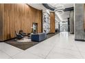 Grand lobby features modern seating, stylish decor, wood paneling, marble floors and columns with abstract art at 943 Peachtree Ne St # 1108, Atlanta, GA 30309
