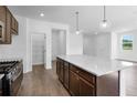 Bright kitchen featuring granite counters, stainless appliances, and an island with pendant lighting at 1420 Windance Lake Dr, Loganville, GA 30052