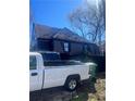 Residential home featuring a gable roof, truck in driveway and a fenced yard at 1483 Hardee Ne St, Atlanta, GA 30307