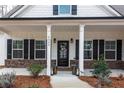 Inviting front door with sidelights, a decorative wreath, and a well-maintained walkway at 6045 Crowley Dr, Douglasville, GA 30135