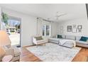 Bright living room with hardwood floors, a ceiling fan, and comfortable seating at 1060 Mclinden Se Ave, Smyrna, GA 30080