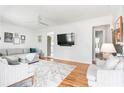 Open living room featuring hardwood floors, a flat screen TV, and comfortable seating at 1060 Mclinden Se Ave, Smyrna, GA 30080