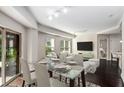 Bright dining room with large windows, a glass dining table, and an open concept to the living room at 200 River Vista Dr # 205, Atlanta, GA 30339